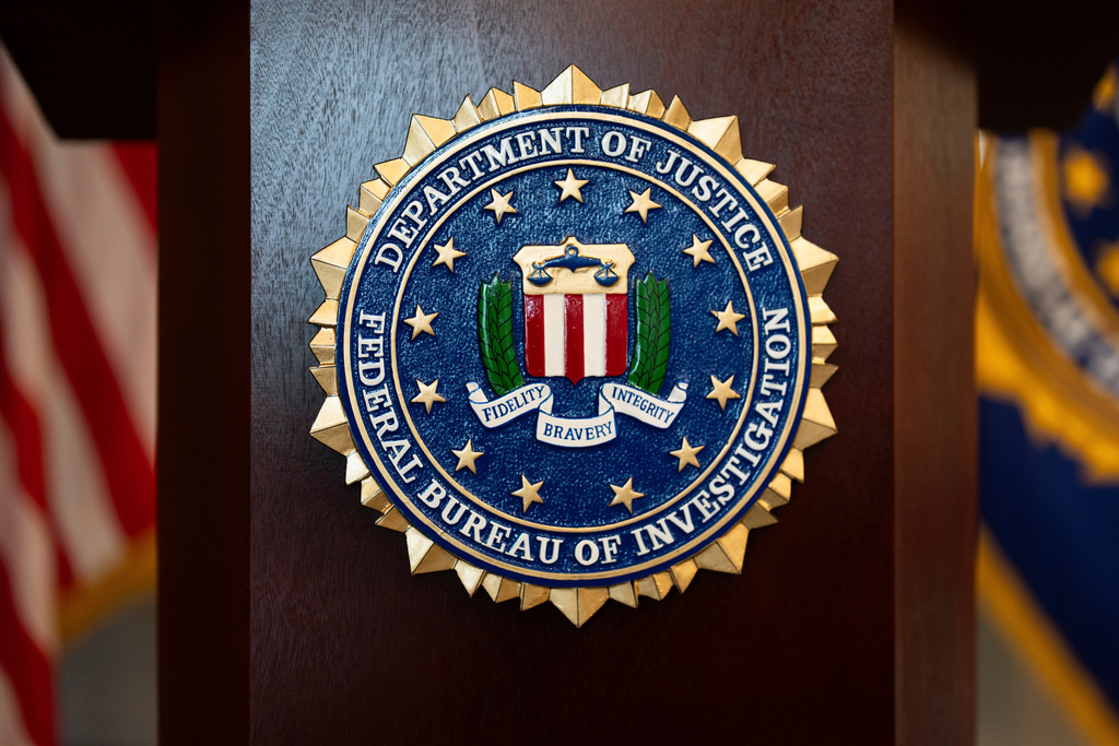 FILE - An FBI seal is displayed on a podium before a news conference in Portland, Ore., Jan. 16, 2025. (AP Photo/Jenny Kane, File)