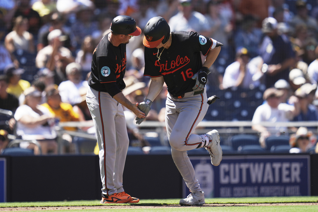 Baltimore Orioles' Coby Mayo celebrates with third base coach Buck Britton after hitting a home run during the third inning of a baseball game against the San Diego Padres Wednesday, Sept. 3, 2025, in San Diego. (AP Photo/Gregory Bull)