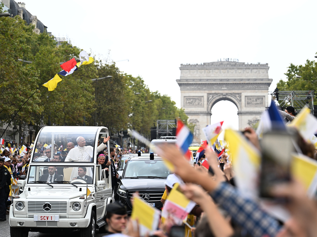 Pope Leo XIV waves to the crowd on the Champs Elysees avenue before a mass at the Place de la Concorde in Paris, Saturday, Sept. 26, 2026. (AP Photo/Emma Da Silva)