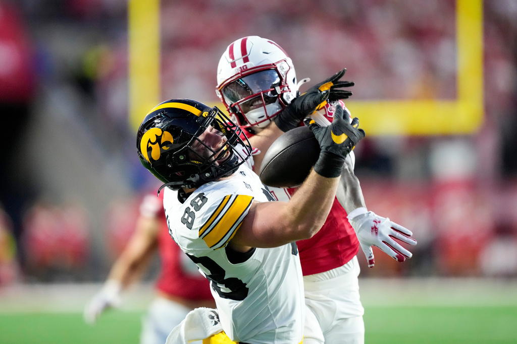 Iowa tight end Hayden Large (88) cannot make a catch near Wisconsin cornerback Omillio Agard, right, during the first half of an NCAA college football game Saturday, Oct. 11, 2025, in Madison, Wis. (AP Photo/Andy Manis)