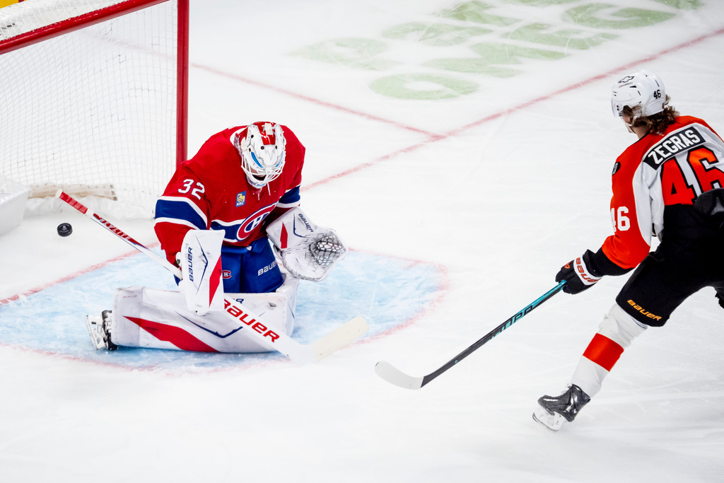 Philadelphia Flyers' Trevor Zegras (46) scores on Montreal Canadiens goaltender Jacob Fowler (32) during the second period of an NHL hockey game, in Montreal, Tuesday, Dec. 16, 2025. (Christopher Katsarov/The Canadian Press via AP)