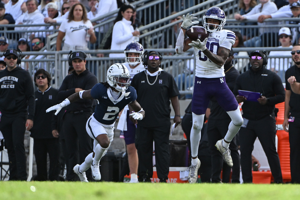 Northwestern wide receiver Hayden Eligon II (80) catches a pass in front of Penn State cornerback Audavion Collins (2) during the second quarter of an NCAA college football game, Saturday, Oct. 11, 2025, in State College, Pa. (AP Photo/Barry Reeger)