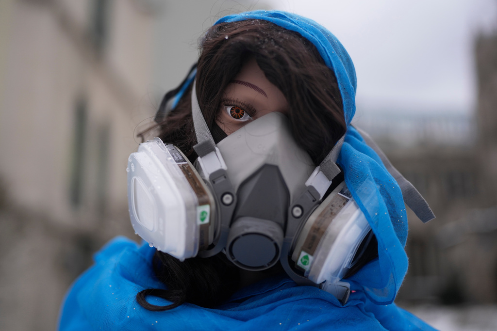 A mannequin representing the Mother Mary wears a mask in the Nativity scene outside of Lake Street Church of Evanston, Wednesday, Dec. 10, 2025, in Evanston, Ill. (AP Photo/Erin Hooley)