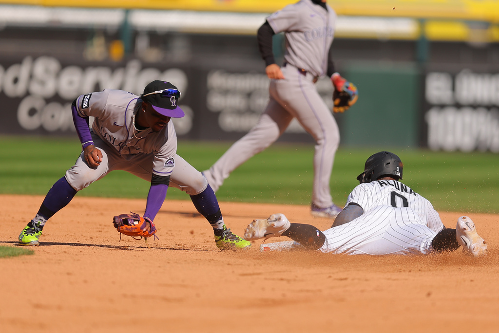 Chicago White Sox's Luisangel Acuña, right, steals second base against Colorado Rockies' Adael Amador, left, during the third inning of a baseball game, Sunday, Sept. 27, 2026, in Chicago. (AP Photo/Melissa Tamez)