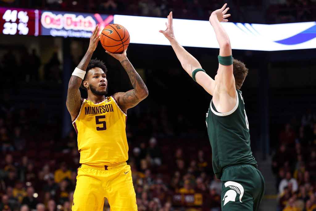 Minnesota forward Jaylen Crocker-Johnson, left, shoots over Michigan State forward Jaxon Kohler during the first half of an NCAA college basketball game, Wednesday, Feb. 4, 2026, in Minneapolis. (AP Photo/Matt Krohn)
