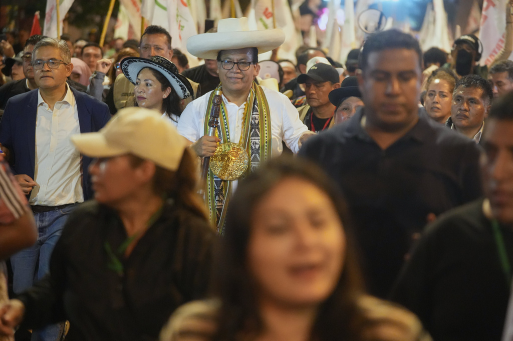 Presidential candidate Roberto Sanchez of the Together for Peru party, center, walks with supporters during a protest against presidential candidate Keiko Fujimori of the Popular Force party in Lima, Peru, Friday, June 19, 2026. (AP Photo/Miguel Paredes)