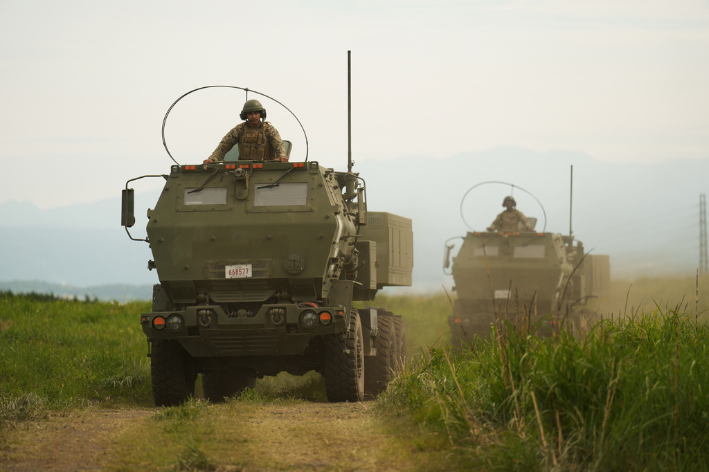 U.S. Marines appear to show the High Mobility Artillery Rocket System (HIMARS) mounted on trucks during a media tour after they conducted its live-fire training at Camp Fuji, in Gotemba, southwest of Tokyo, Wednesday, May 20, 2026. (AP Photo/Hiro Komae)