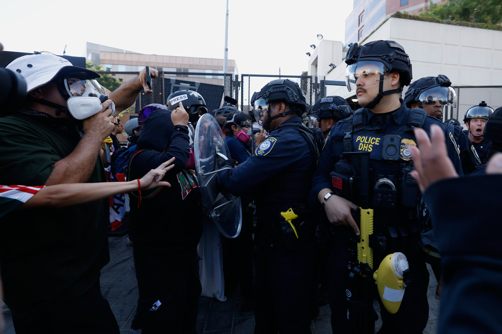 FILE - Protesters confront federal law enforcement agents outside the Metropolitan Detention Center on June 6, 2026, commemorating federal immigration raids and community protests one year ago in Los Angeles. (AP Photo/Jill Connelly, File)