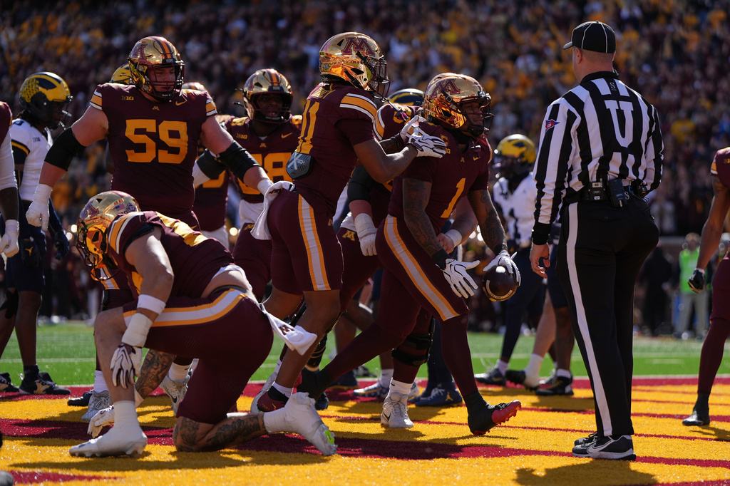 Minnesota running back Darius Taylor (1) celebrates with teammates after scoring a touchdown during the first half of an NCAA college football game against Michigan, Saturday, Oct. 3, 2026, in Minneapolis. (AP Photo/Abbie Parr)