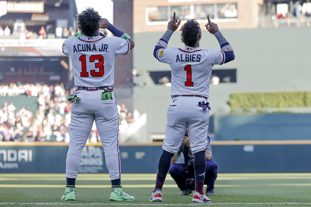 Atlanta Braves' Ronald Acuna Jr. (13) and Ozzie Albies (1) react after the Canadian and United States national anthems before a baseball game against the Toronto Blue Jays, Thursday, June 4, 2026, in Atlanta. (AP Photo/Erik S. Lesser)
