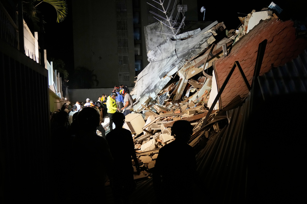 Rescue workers search through the rubble of a collapsed building for survivors after an earthquake in Caracas, Venezuela, Wednesday, June 24, 2026. (AP Photo/Ariana Cubillos)