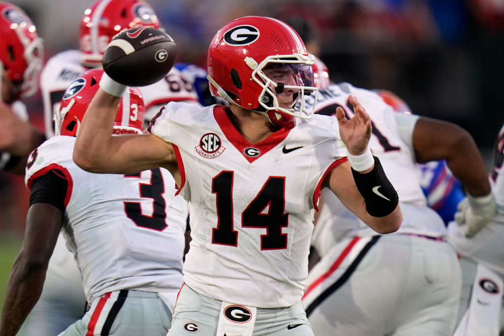Georgia quarterback Gunner Stockton (14) throws a pass against Florida during the second half of an NCAA college football game Saturday, Nov. 1, 2025, in Jacksonville, Fla. (AP Photo/John Raoux)