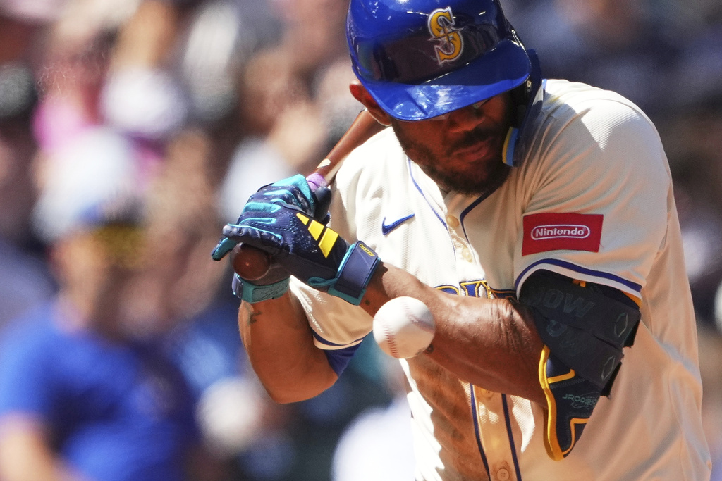 Seattle Mariners' Julio Rodriguez is hit by a pitch against the Tampa Bay Rays during the fourth inning of a baseball game Sunday, Aug. 10, 2025, in Seattle. (AP Photo/Lindsey Wasson)