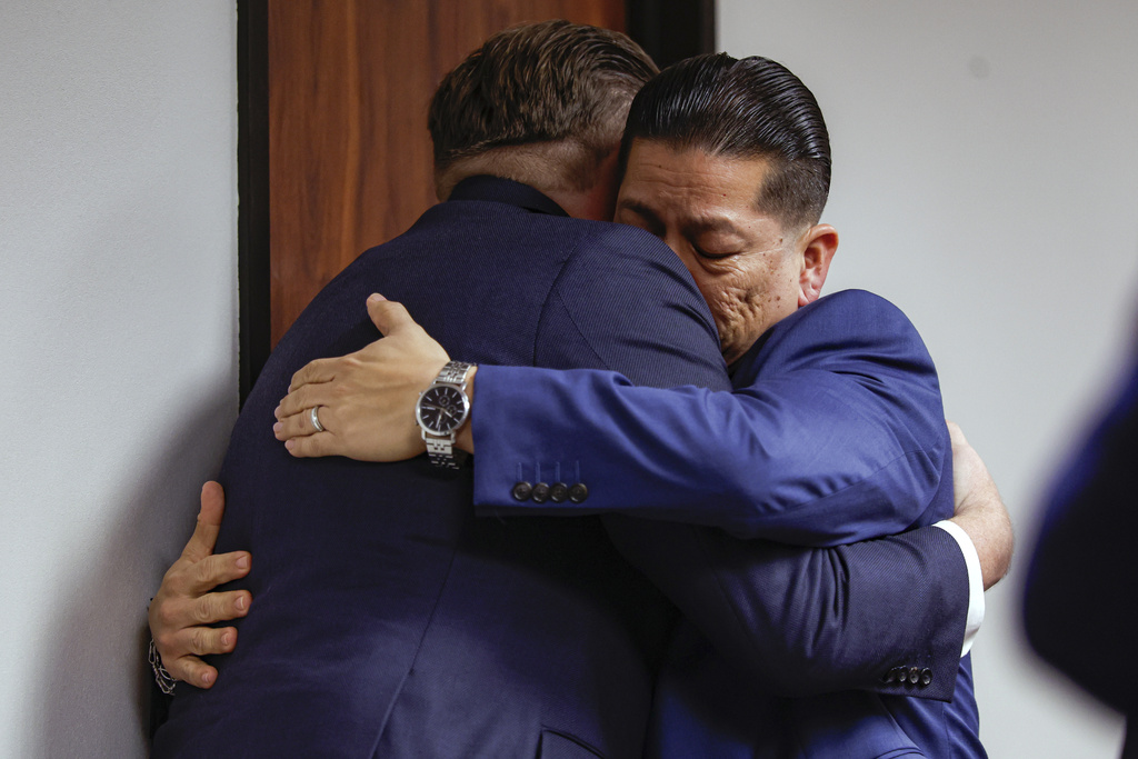 Former Uvalde school district police officer Adrian Gonzales, right, embraces his attorney Jason Goss after the jury found Gonzales not guilty at the Nueces County Courthouse on Wednesday, Jan. 21, 2026, in Corpus Christi, Texas. (Sam Owens/The San Antonio Express-News via AP, Pool)