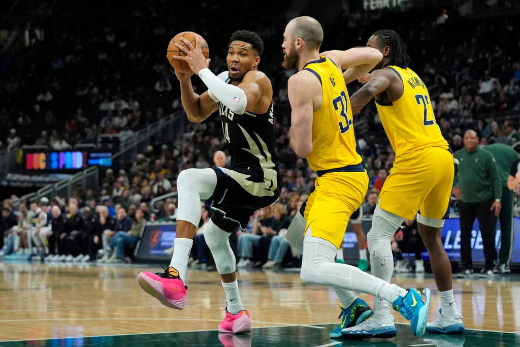 Milwaukee Bucks' Giannis Antetokounmpo (34) spins as he drives to the basket against Indiana Pacers' Jay Huff (32) during the second half of an NBA basketball game, Sunday, March 15, 2026, in Milwaukee. (AP Photo/Aaron Gash)