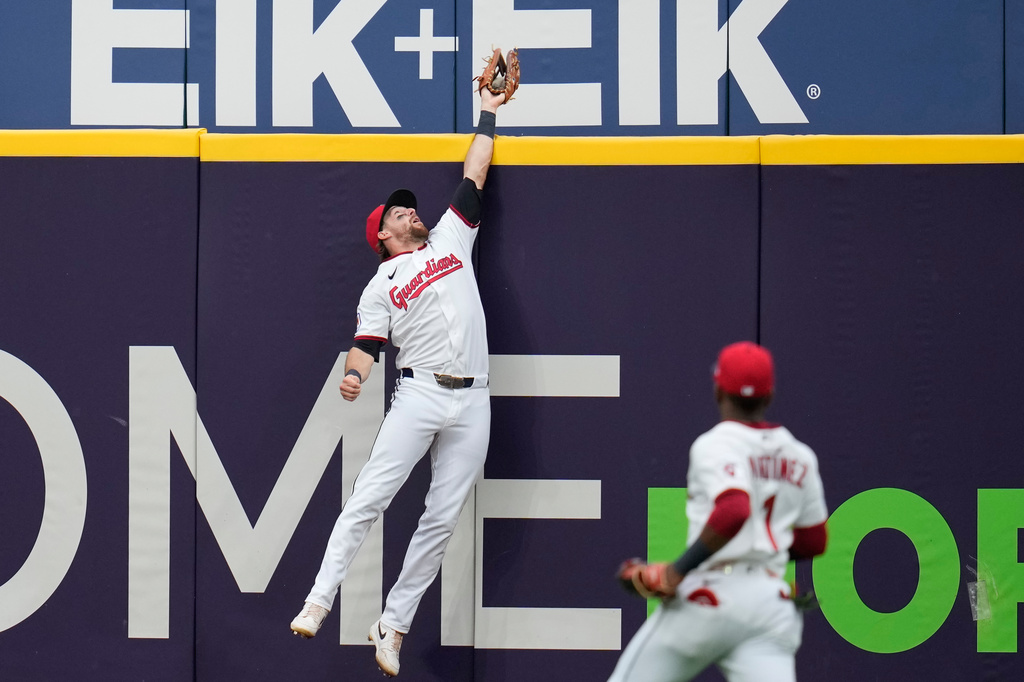 Cleveland Guardians center fielder Daniel Schneemann catches a fly ball hit for an out by Washington Nationals' Curtis Mead in the fourth inning of a baseball game in Cleveland, Tuesday, May 26, 2026. (AP Photo/Sue Ogrocki)