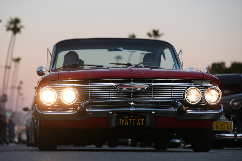 Lowriders cruise at the 6th Annual Lady Lowrider Cruise Night in celebration of International Women's Day in Pasadena, Calif., on Sunday, March 8, 2026. (AP Photo/Damian Dovarganes)