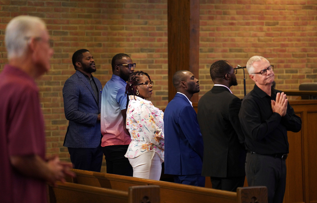 FILE - Members of the Haitian community, from left, Lindsay Aime, James Fleurijean, Rose-Thamar Joseph, Harold Herard, and Viles Dorsainvil, stand for worship with Carl Ruby, pastor at Central Christian Church, in Springfield, Ohio, on Sept. 15, 2024. (AP Photo/Jessie Wardarski, file)