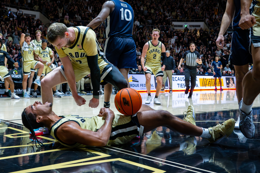 Purdue guards C.J. Cox, bottom, and Braden Smith react after Cox was fouled on a play during the second half of an NCAA college basketball game against Penn State, Saturday, Jan. 10, 2026, in West Lafayette, Ind. (AP Photo/Doug McSchooler)