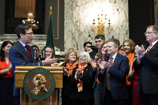 FILE -Washington Attorney General Bob Ferguson introduces Sen. Jamie Pedersen, D-Seattle, second from right, after making remarks Tuesday, April 25, 2023, at the Capitol in Olympia, Wash. A federal judge on Friday, March 8, 2024 rejected a challenge to a Washington state law that cleared the way for lawsuits against the gun industry in certain cases. The measure was one of three bills signed by Democratic Gov. Jay Inslee last year seeking to address gun violence. (AP Photo/Lindsey Wasson, File)