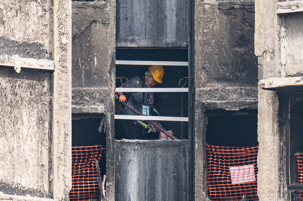A resident of Wang Fuk Court retrieves belongings five months after the deadly fire in Hong Kong Monday, April 20, 2026. (AP Photo/Chan Long Hei)