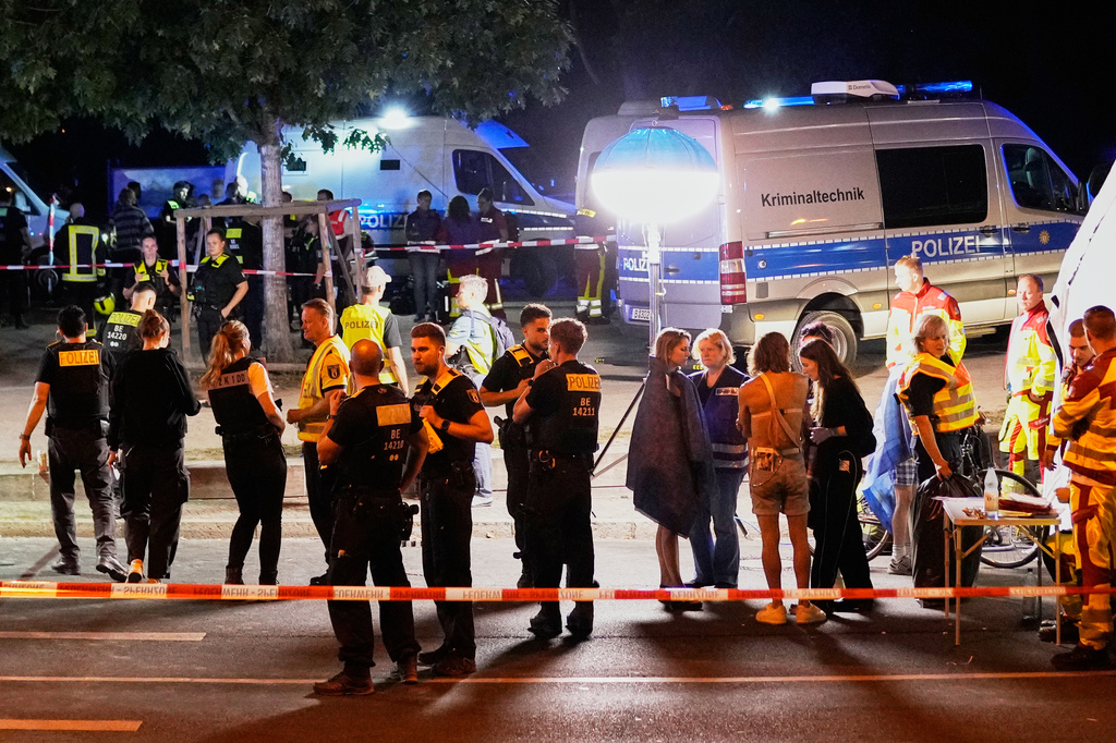 Emergency personnel and police gather in Berlin, early Sunday, July 26, 2026, following the cancellation of Christopher Street Day festivities. (AP Photo/Ebrahim Noroozi)