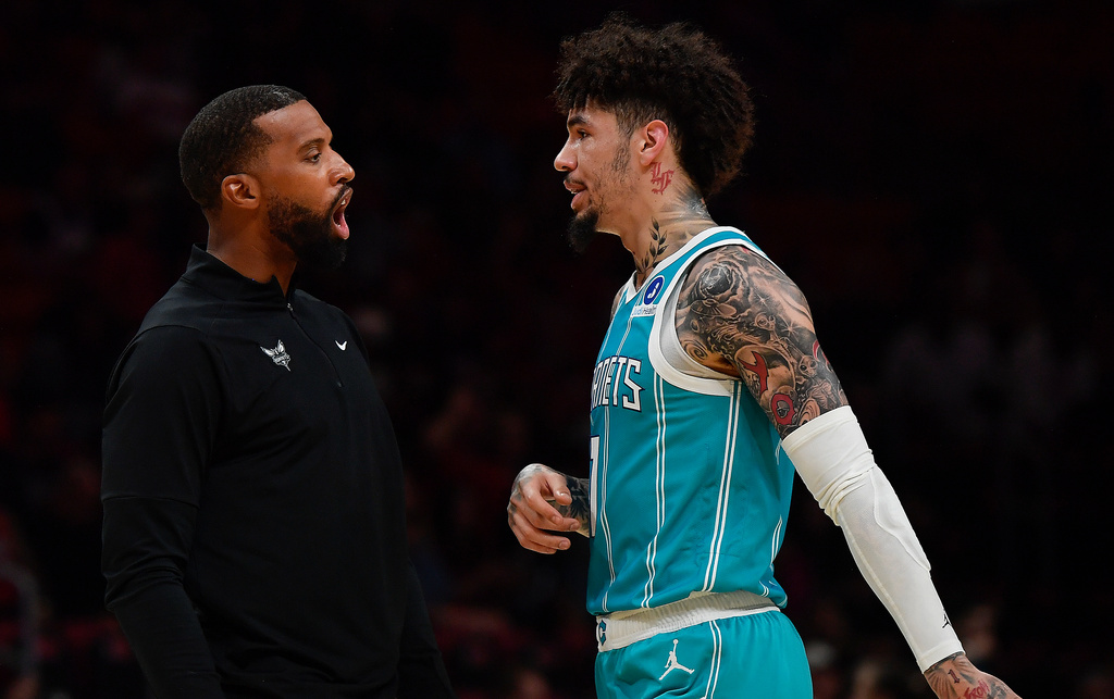 Charlotte Hornets coach Charles Lee talks to LaMelo Ball during the first half of an NBA basketball game against the Miami Heat, Tuesday, Oct. 28, 2025, in Miami. (AP Photo/Michael Laughlin)