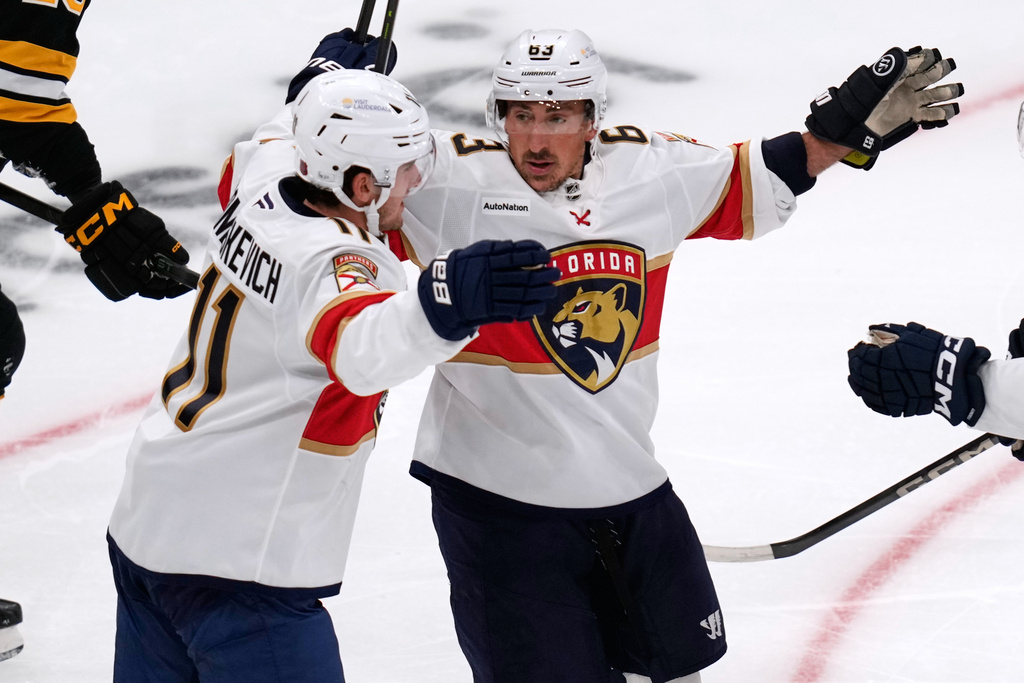 Florida Panthers left wing Brad Marchand, right, celebrates after a goal by right wing Mackie Samoskevich (11) during the first period of an NHL hockey game, Tuesday, Oct. 21, 2025, in Boston. (AP Photo/Charles Krupa)
