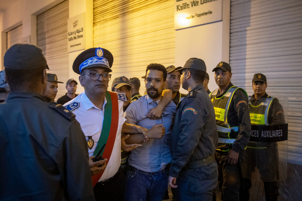 Security forces disperse and arrest protesters during a demonstration demanding healthcare and education reforms, in Rabat, Sunday, Sept. 28, 2025. (AP Photo)