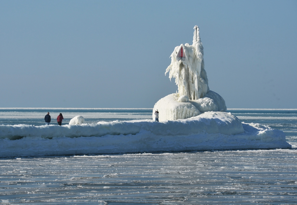 Ice covers a navigational beacon at the end of the South Pier along Lake Michigan, Friday, Feb. 13, 2026, in St. Joseph, Mich. (Don Campbell/The Herald-Palladium via AP)