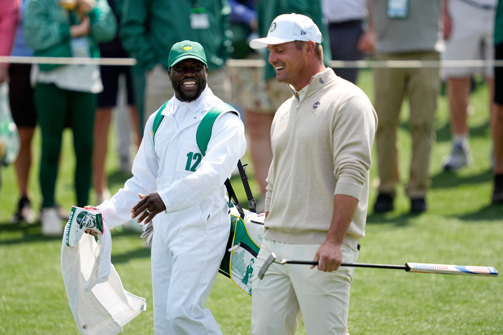 Actor Kevin Hart, left, and Bryson DeChambeau laugh during par-3 contest ahead of the Masters golf tournament at the Augusta National Golf Club, Wednesday, April 8, 2026, in Augusta, Ga. (AP Photo/Ashley Landis)