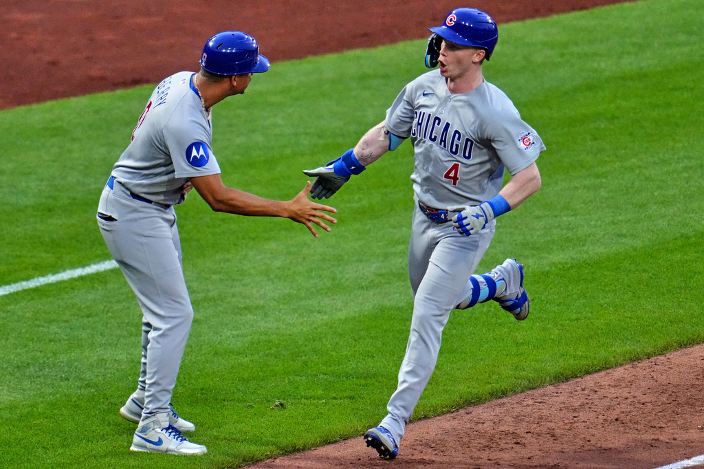 Chicago Cubs' Pete Crow-Armstrong (4) is greeted by third base coach Quintin Berry, left, as he rounds third after hitting a solo home run off Pittsburgh Pirates pitcher Jared Jones during the sixth inning of a baseball game in Pittsburgh, Friday, July 24, 2026. (AP Photo/Gene J. Puskar)