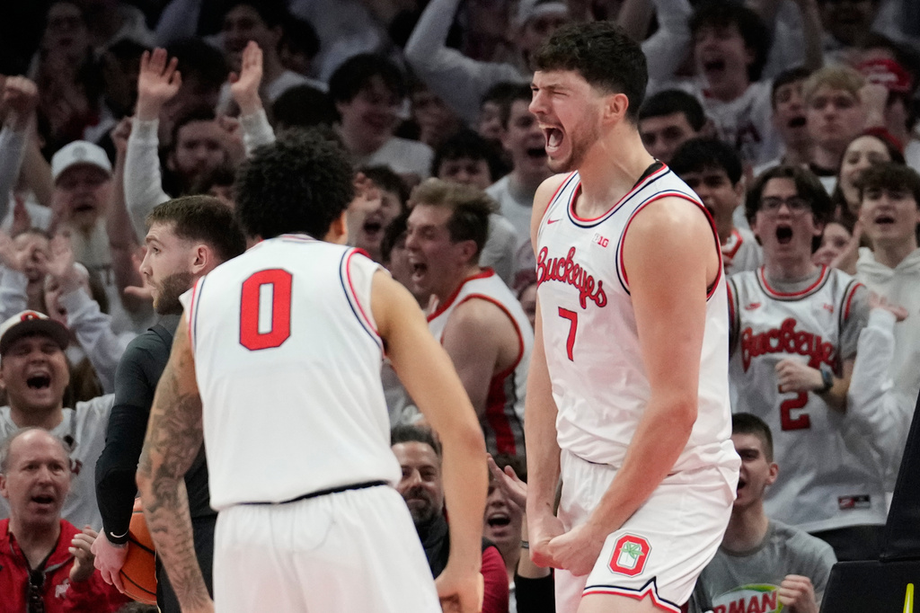 Ohio State center Ivan Njegovan (7) celebrates a dunk with teammate John Mobley Jr. (0) in the first half of an NCAA college basketball game against Purdue Sunday, March 1, 2026, in Columbus, Ohio. (AP Photo/Sue Ogrocki)