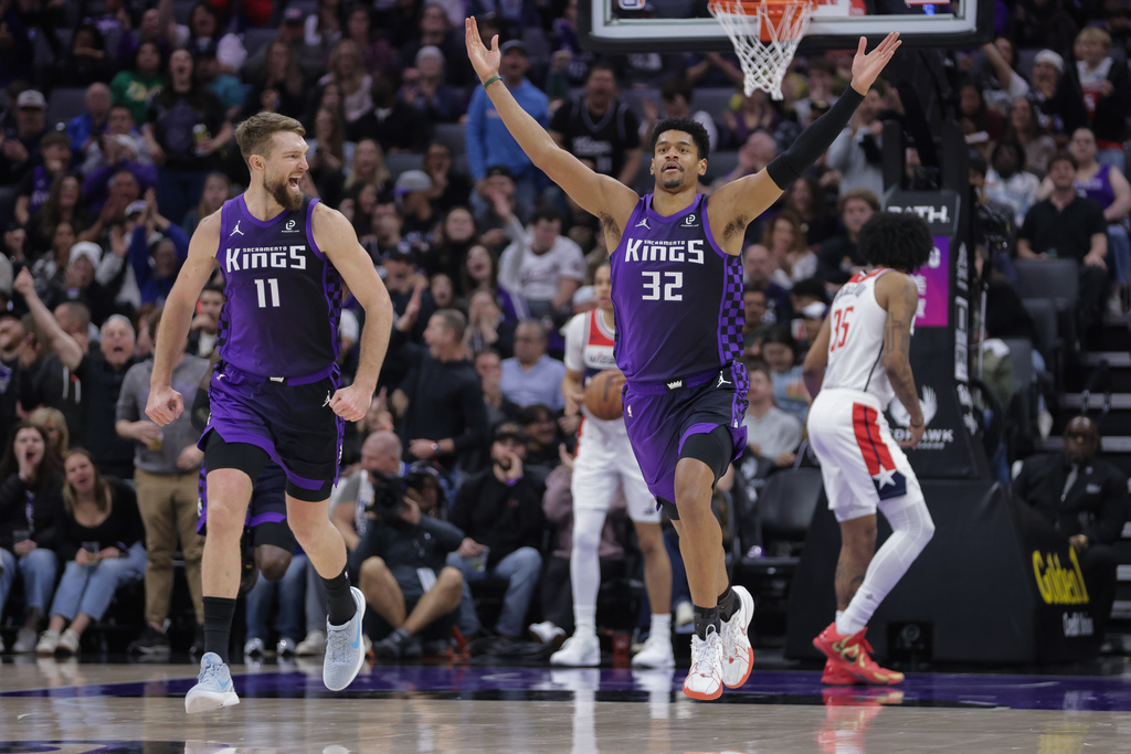 Sacramento Kings center Dylan Cardwell (32) reacts after dunking the ball during the first half of an NBA basketball game against the Washington Wizards, Friday, Jan. 16, 2026, in Sacramento, Calif. (AP Photo/Scott Marshall)