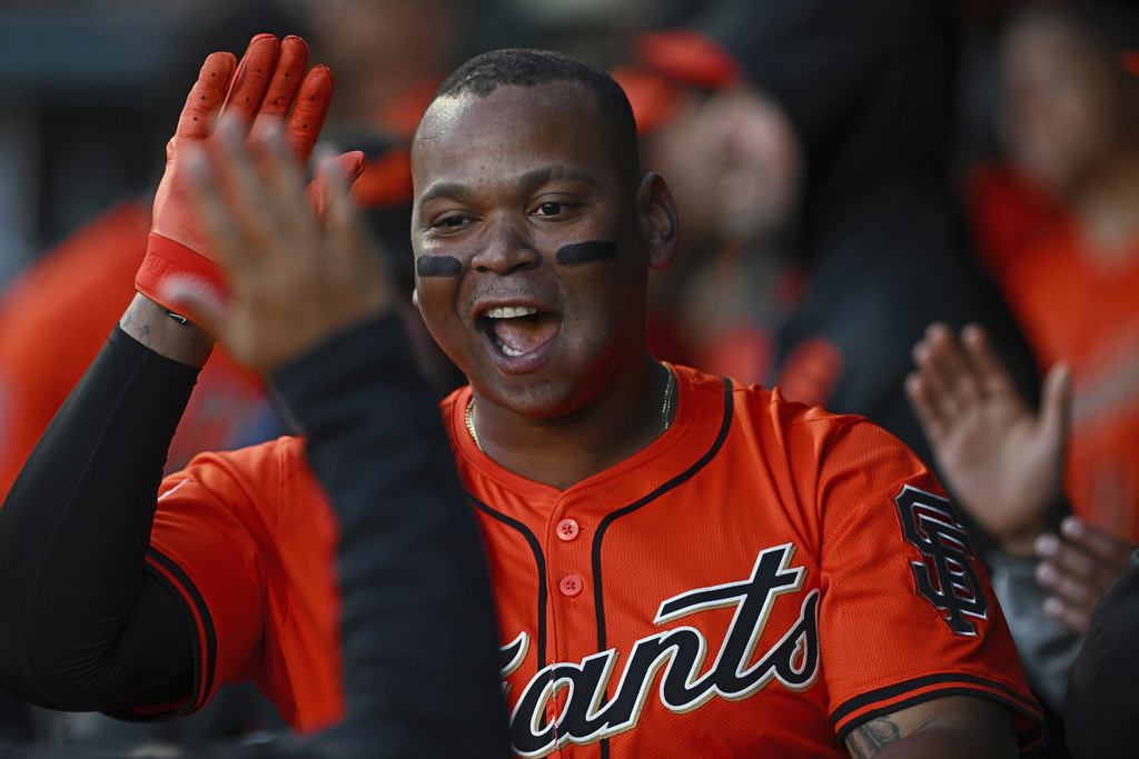 San Francisco Giants' Rafael Devers is congratulated in the dugout after he hit a solo home run in the first inning of a baseball game against the Washington Nationals in San Francisco, Friday, Aug. 8, 2025. (Jose Carlos Fajardo/Bay Area News Group via AP)