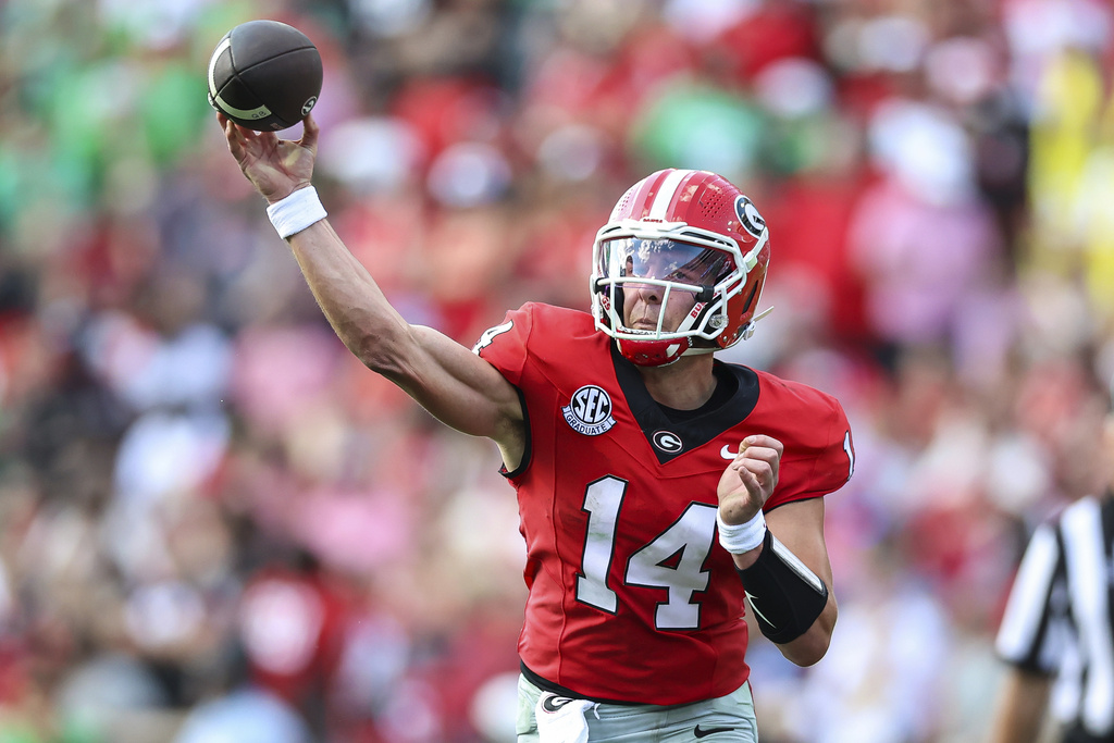 Georgia quarterback Gunner Stockton (14) throws a pass during the first half of an NCAA college football game against Marshall, Saturday, Aug. 30, 2025, in Athens, Ga. (AP Photo/Colin Hubbard)