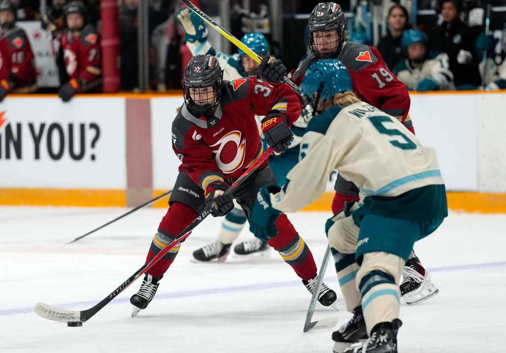 Ottawa Charge's Rebecca Leslie (37) looks to pass the puck as Seattle Torrent's Anna Wilgren (5) defends, during first period PWHL hockey action in Ottawa, on Wednesday, Jan. 28, 2026. (Justin Tang/The Canadian Press via AP)
