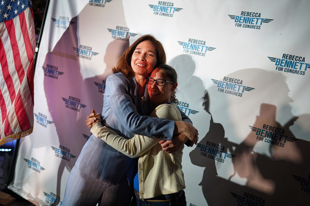 Rebecca Bennett, Democratic candidate for New Jersey's 7th Congressional District, hugs an attendee during a primary election night watch party after winning the Democratic nomination Tuesday, June 2, 2026, in Bridgewater, N.J. (AP Photo/Ryan Murphy)
