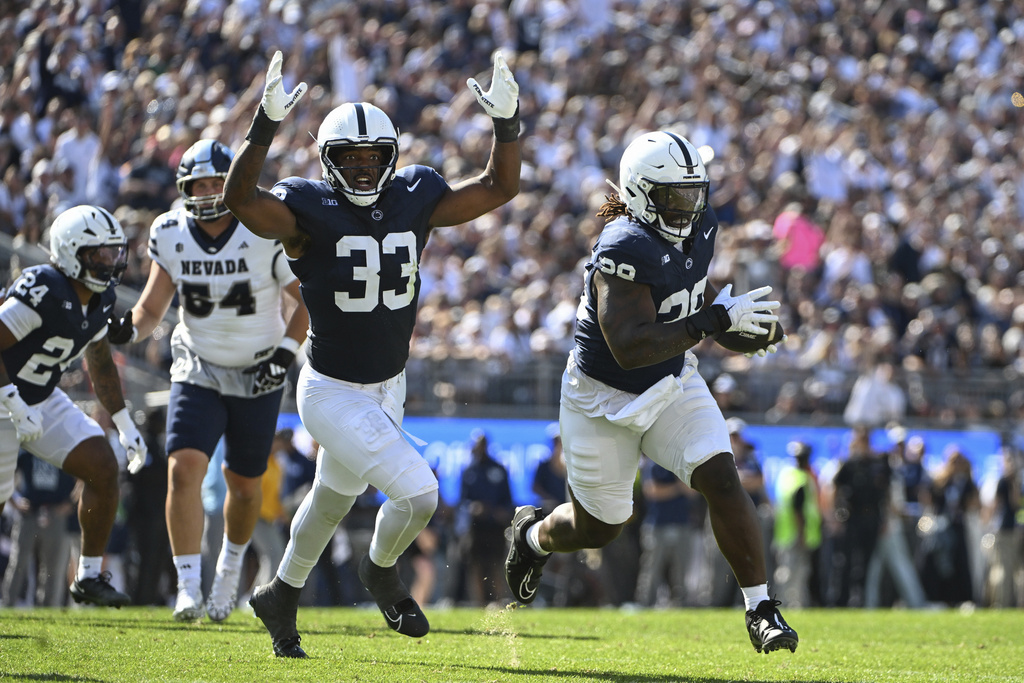 Penn State defensive tackle Zane Durant (28) returns an interception against Nevada during the first quarter of an NCAA college football game, Saturday, Aug. 30, 2025, in State College, Pa. (AP Photo/Barry Reeger)