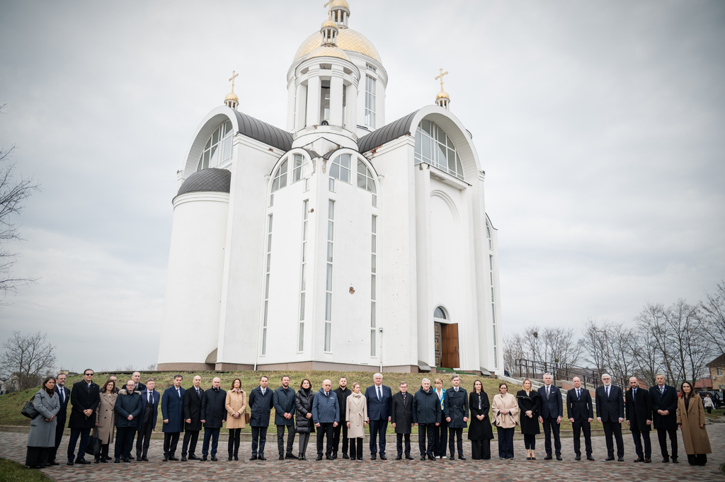 In this photo provided by the Ukrainian Foreign Ministry Press Office, High Representative of the European Union for Foreign Affairs and Security Policy Kaja Kallas, center left, Ukraine's Foreign Minister Andrii Sybiha, center right, and EU foreign ministers attend a commemorating ceremony in Bucha, Ukraine, Tuesday, March 31, 2026. (Ukrainian Foreign Ministry Press Office via AP)