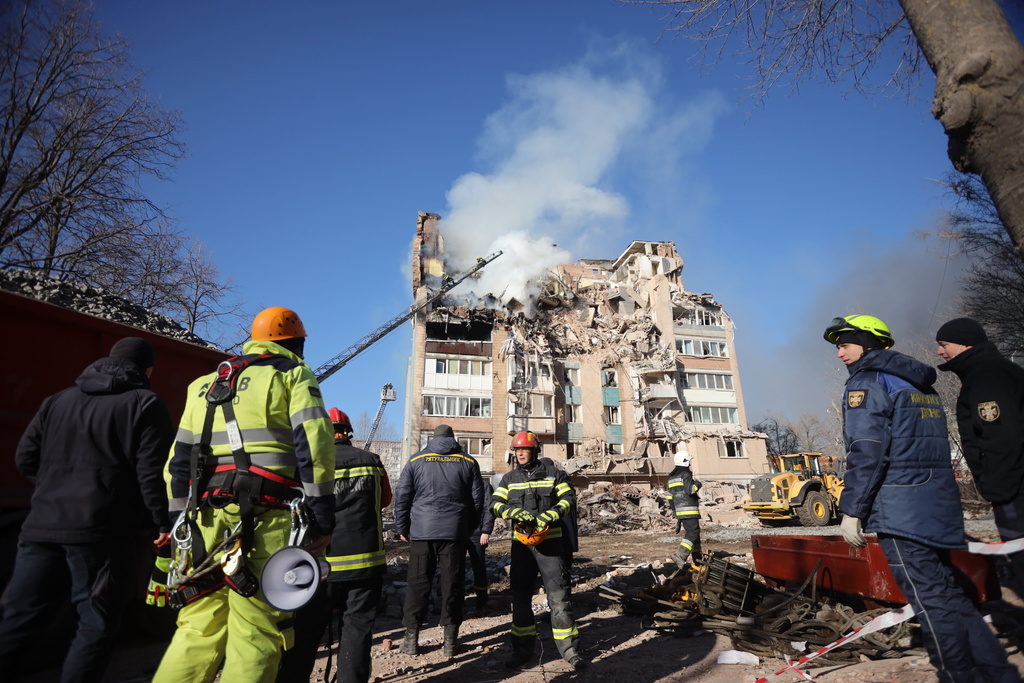Rescue workers put out a fire of a residential building which was damaged by a Russian strike on Ternopil, Ukraine, on Wednesday, Nov. 19, 2025. (AP Photo/Rostyslav Kovalchuk)