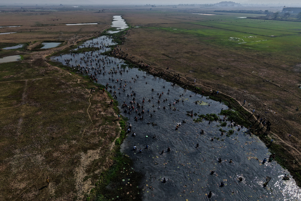 Villagers participate in a community fishing as part of Bhogali Bihu celebrations which mark the end of the harvest season at Jalikhora village east of Guwahati, India, Tuesday, Jan. 13, 2026. (AP Photo/Anupam Nath)