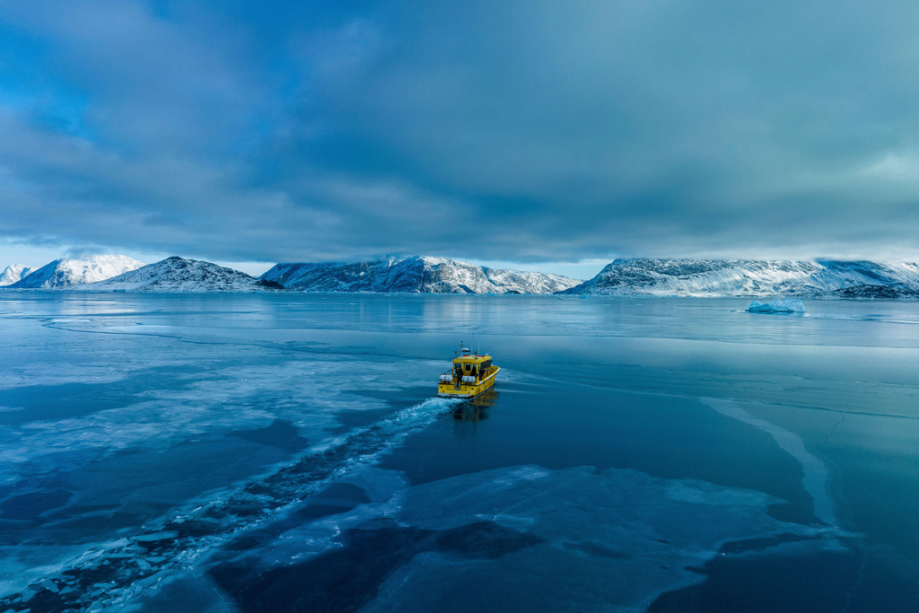 FILE - A boat rides though a frozen sea inlet outside of Nuuk, Greenland, on March 6, 2025. (AP Photo/Evgeniy Maloletka, File)