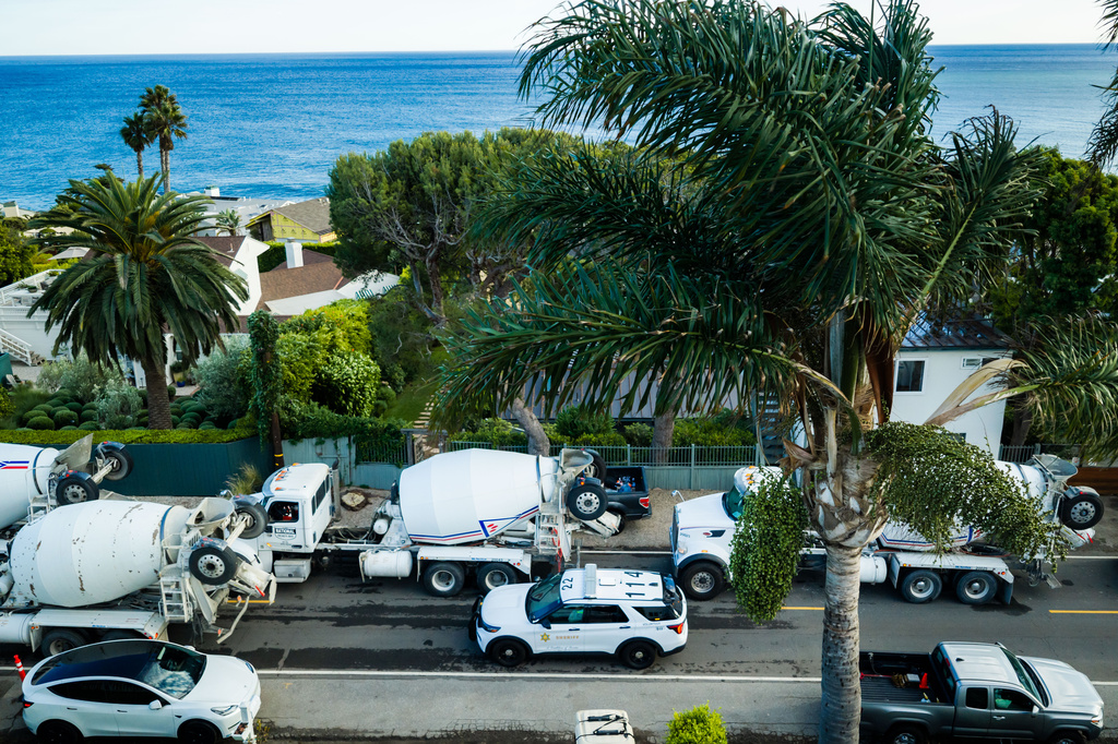 An aerial view construction vehicles lined up near a sinkhole which collapsed the driveway of a coastal mansion owned by actor Nicolas Cage Tuesday, Sept. 8, 2026, in Malibu, Calif. (AP Photo/Ethan Swope)