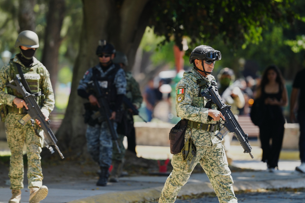 Mexican army soldiers patrol outside Recinto de Paz cemetery in Guadalajara, Mexico, Monday, March 2, 2026. (AP Photo/Refugio Ruiz)
