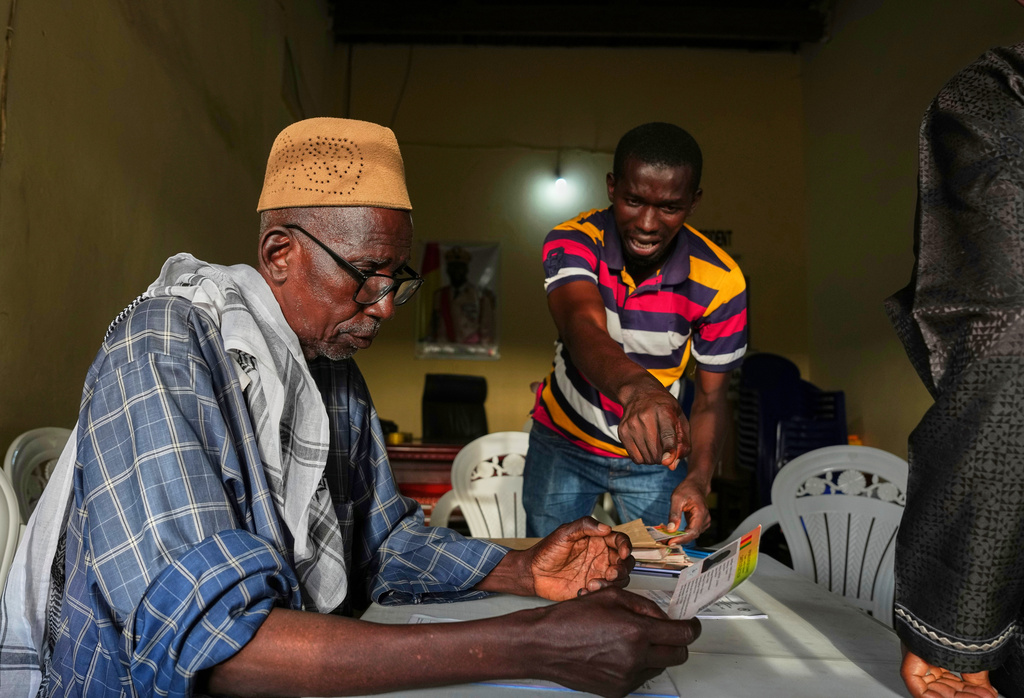 Officials work at a polling station during the constitutional referendum in Conakry, Guinea, Sunday, Sept. 21, 2025. (AP Photo/Misper Apawu)