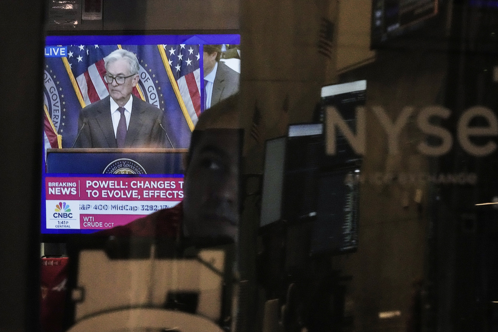 Federal Reserve Chair Jerome Powell's news conference is displayed on a television screen as trader Robert Greason works at his post on the floor of the New York Stock Exchange, Wednesday, Sept. 17, 2025. (AP Photo/Richard Drew)