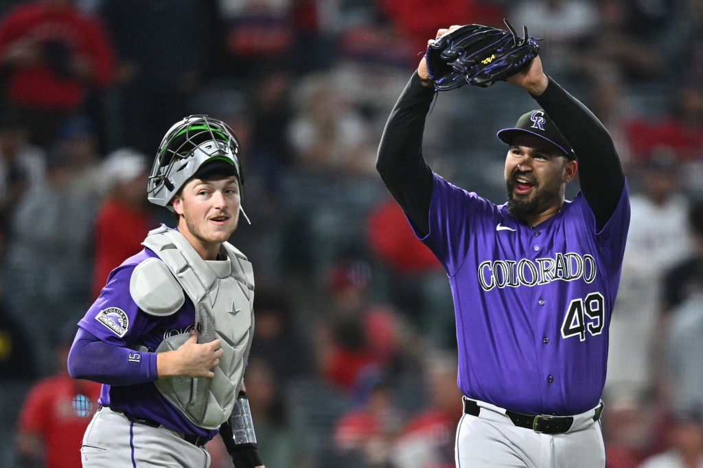 Colorado Rockies pitcher Antonio Senzatela (49) gestures after getting a double play during the ninth inning of a baseball game to defeat the Los Angeles Angels, Monday, June 1, 2026, in Anaheim, Calif. (AP Photo/William Liang)