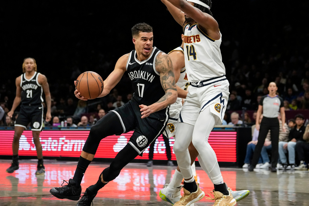 Brooklyn Nets forward Michael Porter Jr. (17) falls as he attempts to shoot during the first half of an NBA basketball game against the Denver Nuggets, Sunday, Jan. 4, 2026, in New York. (AP Photo/Yuki Iwamura)