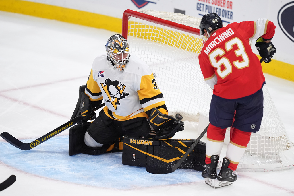Florida Panthers left wing Brad Marchand (63) scores his team's first goal past Pittsburgh Penguins goaltender Tristan Jarry (35) during the second period of an NHL hockey game, Thursday, Oct. 23, 2025, in Sunrise, Fla. (AP Photo/Rebecca Blackwell)